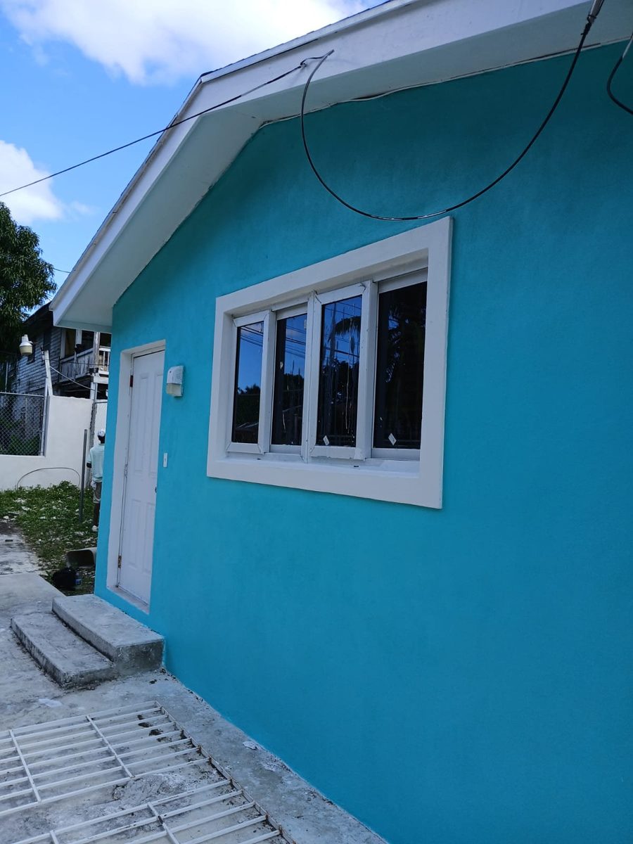 Bright teal home with crisp white window trim