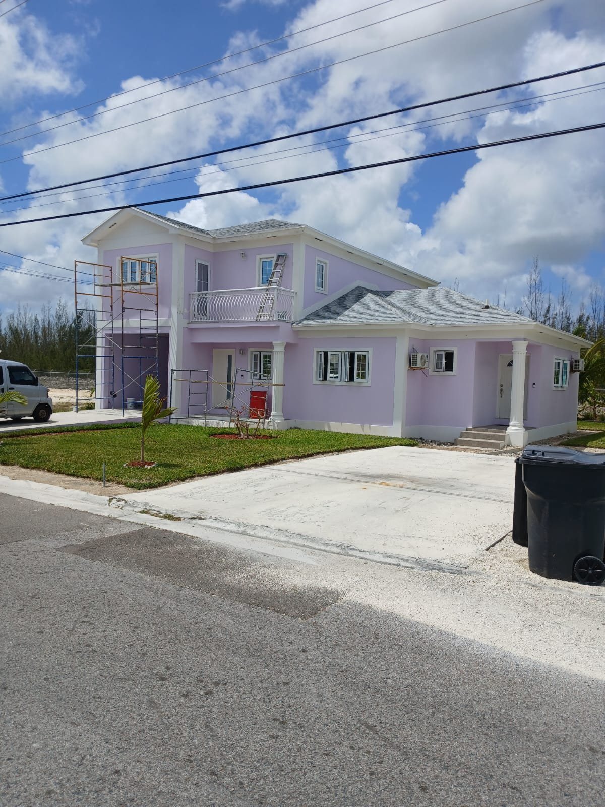 Finished lavender two-story home with white trim